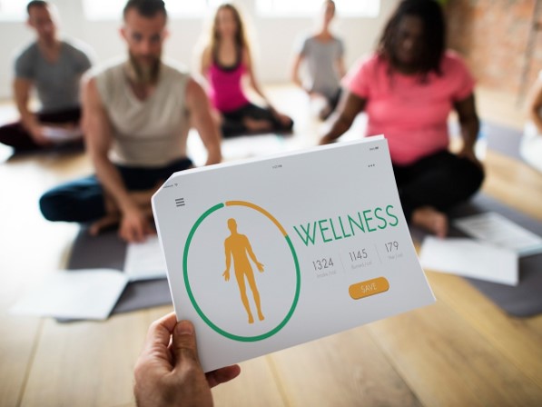 Wellness coach reviewing a client's wellness data during a group mindfulness and wellbeing session