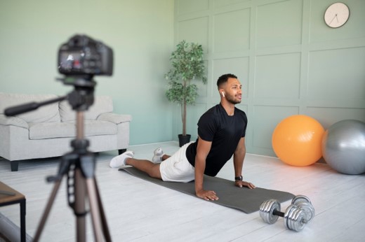 Client completing a guided home workout on a mat while recording it for online coaching video feedback